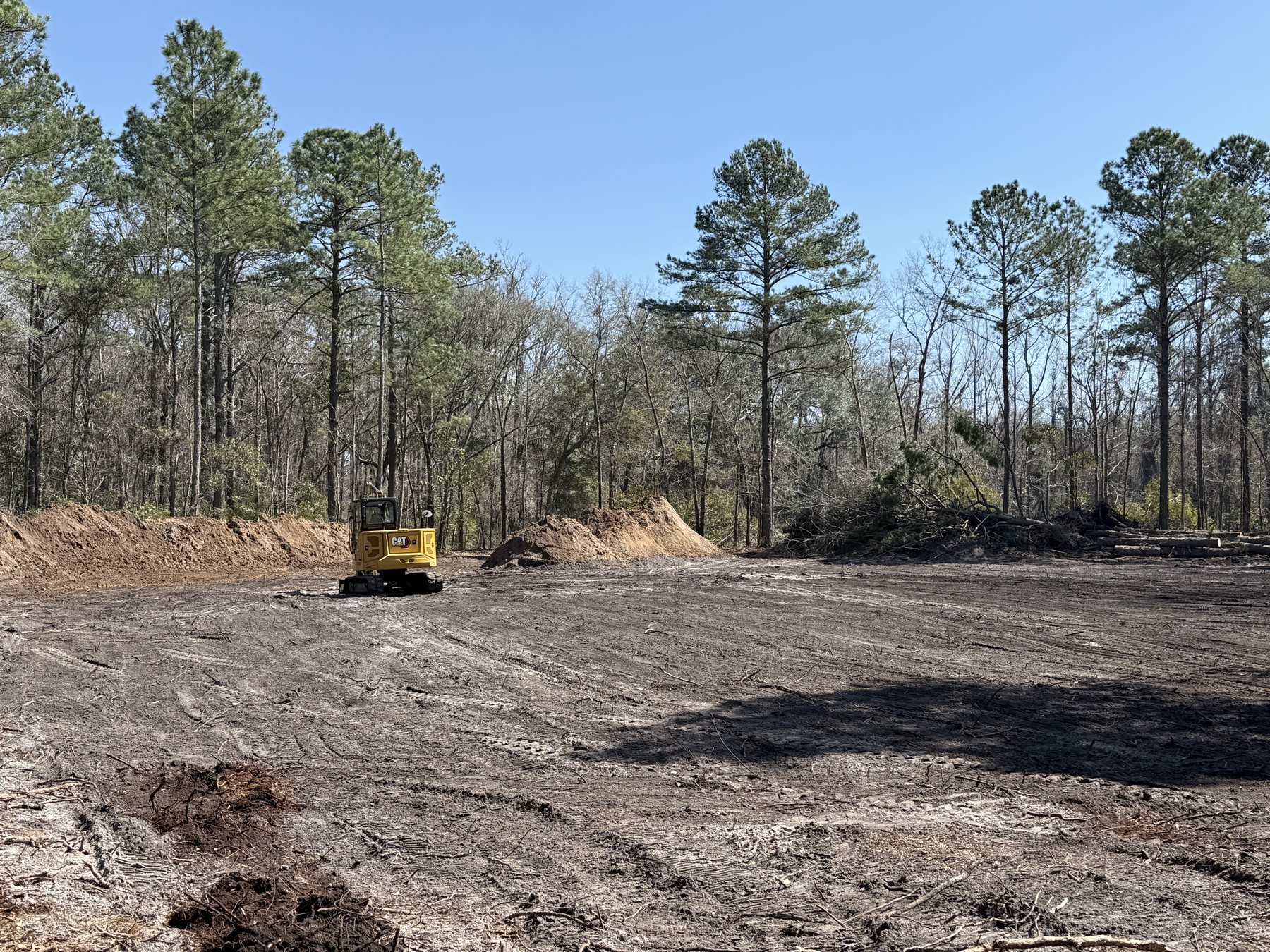 Wide view of a rural lot cleared down to open ground