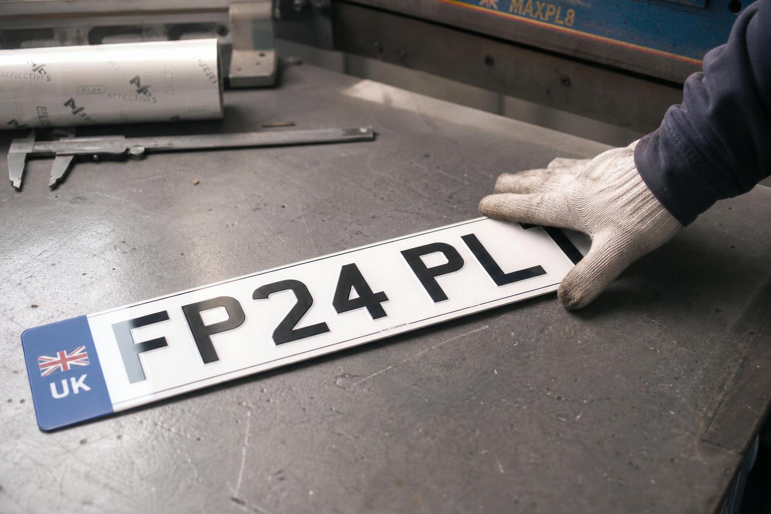 Fast Plates manufacturing a UK rear number plate on a precision press